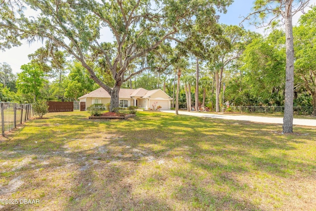 1692 Old Tomoka Rd Unit W, Ormond Beach, FL 32174 - view of yard with driveway, an attached garage, and view of scattered trees