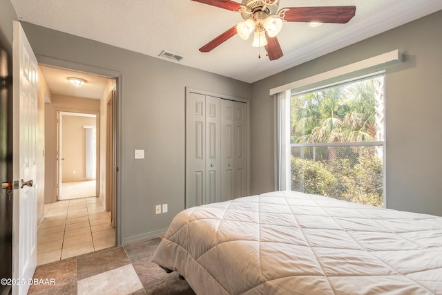 1692 Old Tomoka Rd Unit W, Ormond Beach, FL 32174 - bedroom with a closet, baseboards, a ceiling fan, and light tile patterned flooring