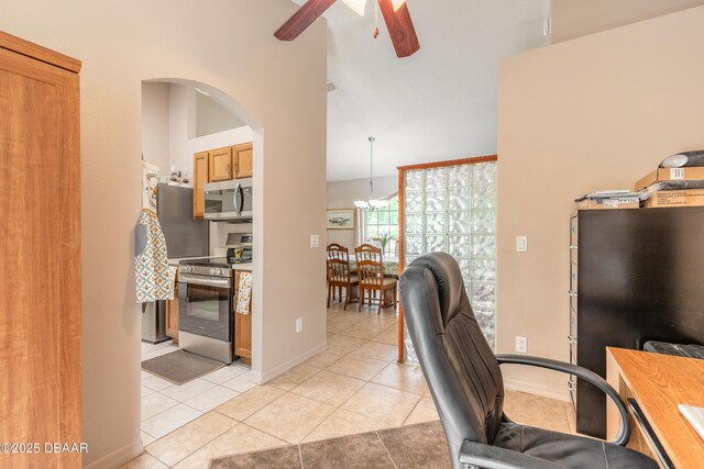 1692 Old Tomoka Rd Unit W, Ormond Beach, FL 32174 - office area featuring ceiling fan, light tile patterned floors, arched walkways, baseboards, and a high ceiling