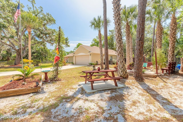 1692 Old Tomoka Rd Unit W, Ormond Beach, FL 32174 - view of yard with concrete driveway and a garage