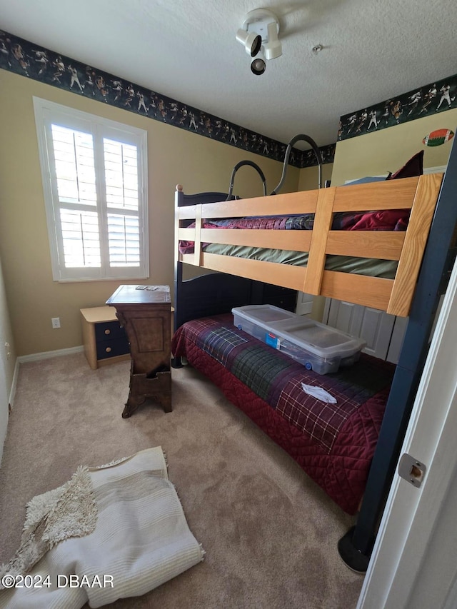 carpeted bedroom featuring a textured ceiling