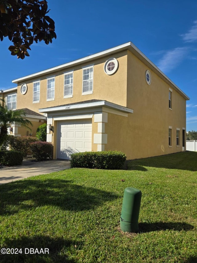 view of front of home with a front yard and a garage