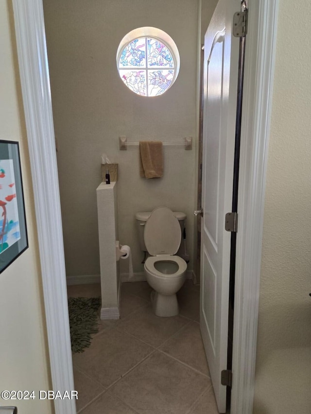 bathroom with tile patterned flooring and toilet