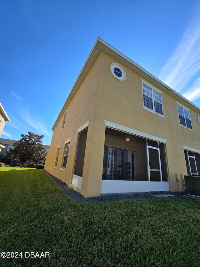 rear view of house featuring a yard