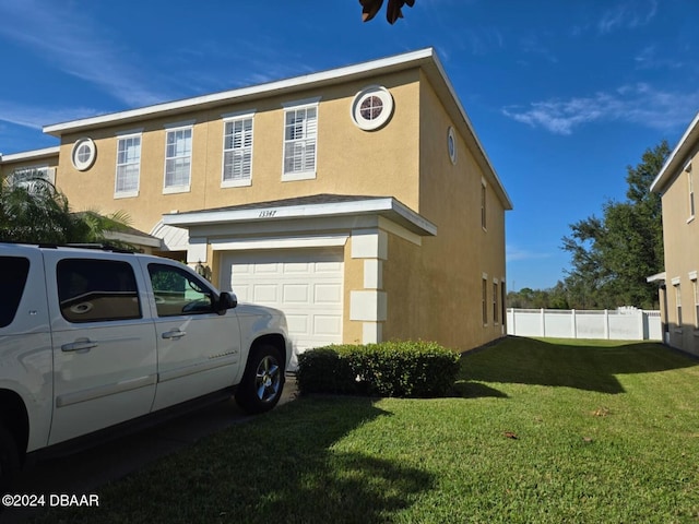 view of home's exterior featuring a garage and a yard