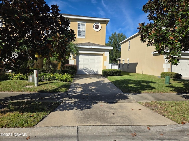 front facade featuring a garage and a front yard