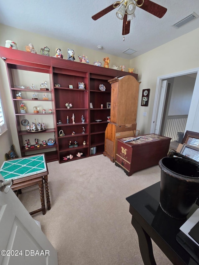 bedroom featuring ceiling fan, a textured ceiling, and carpet floors