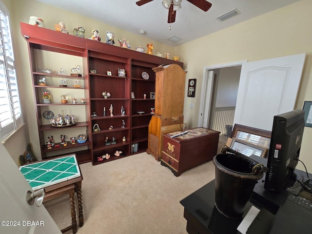 interior space featuring carpet flooring and ceiling fan