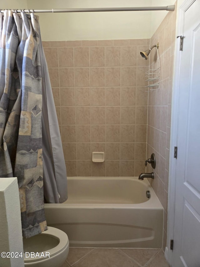 bathroom with tile patterned flooring, shower / bathtub combination with curtain, and toilet