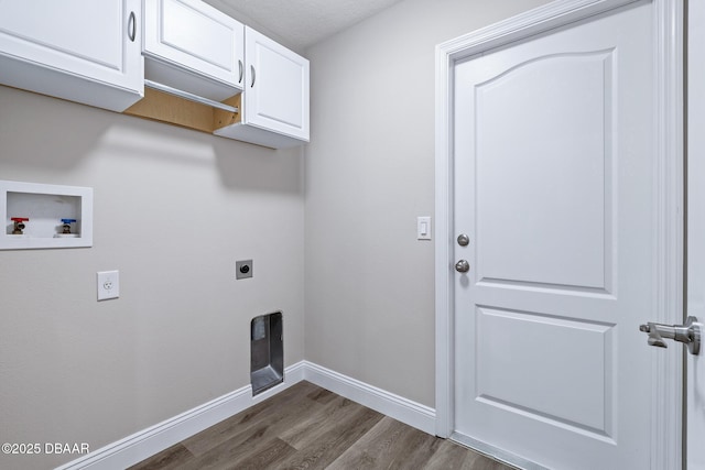 7 Traceway Ct, Ormond Beach, FL 32174 - laundry area with hookup for an electric dryer, hookup for a washing machine, cabinet space, and dark wood-style floors