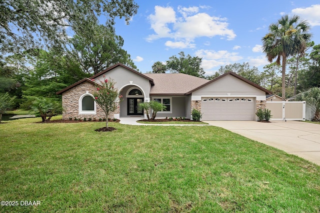 7 Traceway Ct, Ormond Beach, FL 32174 - view of front of property featuring stone siding, a garage, driveway, stucco siding, and a gate