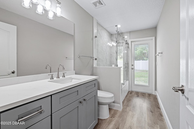 7 Traceway Ct, Ormond Beach, FL 32174 - full bathroom with wood finished floors, vanity, and a textured ceiling