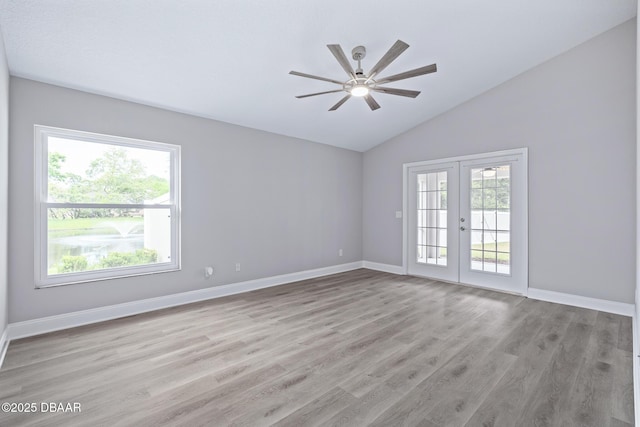 7 Traceway Ct, Ormond Beach, FL 32174 - empty room featuring french doors, lofted ceiling, a ceiling fan, and light wood finished floors