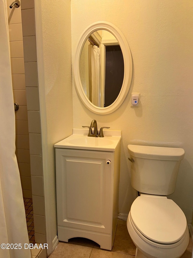 full bathroom with toilet, vanity, a shower with curtain, baseboards, and tile patterned floors