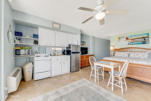 kitchen featuring white cabinets, ceiling fan, a textured ceiling, and appliances with stainless steel finishes