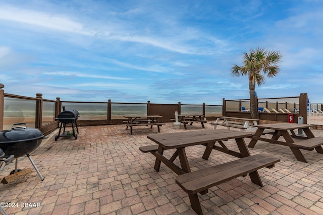 view of patio / terrace featuring a water view and grilling area