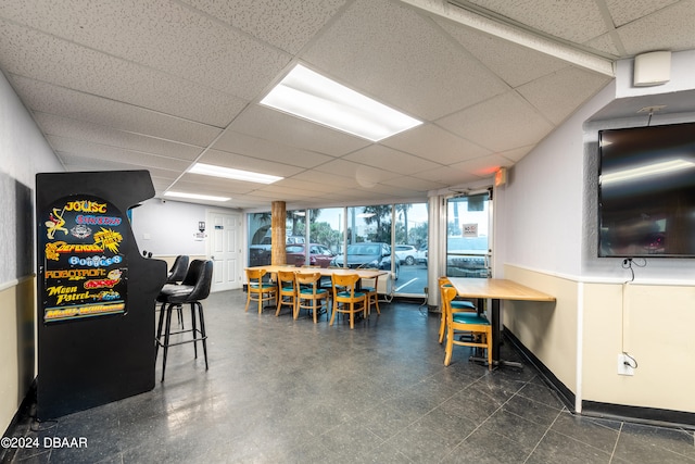 recreation room featuring a paneled ceiling