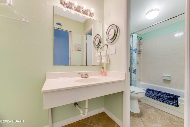 full bathroom featuring tile patterned floors, toilet, shower / bathtub combination with curtain, and sink