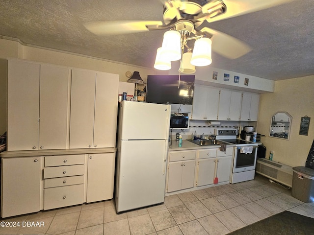 1233 S Atlantic Ave Unit 3310, Daytona Beach, FL 32118 - kitchen with white appliances, a sink, light tile patterned floors, a textured ceiling, and a ceiling fan