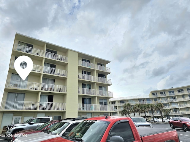 1233 S Atlantic Ave Unit 3310, Daytona Beach, FL 32118 - view of apartment building / complex featuring uncovered parking