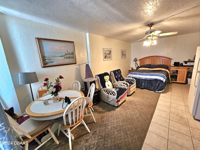 1233 S Atlantic Ave Unit 3310, Daytona Beach, FL 32118 - bedroom featuring a textured wall, a textured ceiling, light tile patterned floors, and ceiling fan