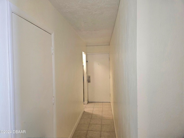 1233 S Atlantic Ave Unit 3310, Daytona Beach, FL 32118 - corridor featuring light tile patterned floors and a textured ceiling