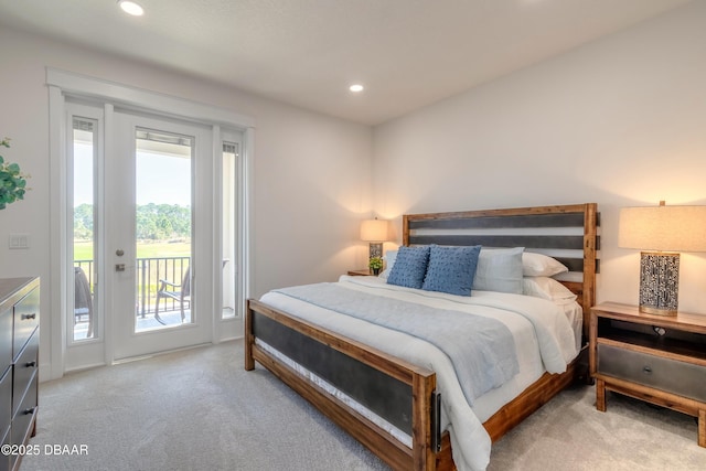 bedroom with multiple windows, light colored carpet, and access to exterior