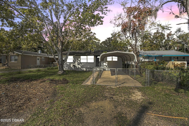 656 Winchester St, Daytona Beach, FL 32114 - back of house featuring a yard, fence, driveway, and a detached carport