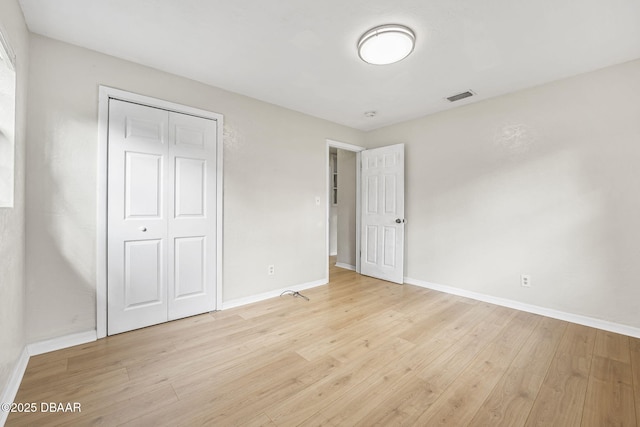 656 Winchester St, Daytona Beach, FL 32114 - unfurnished bedroom with visible vents, baseboards, a closet, and light wood-type flooring