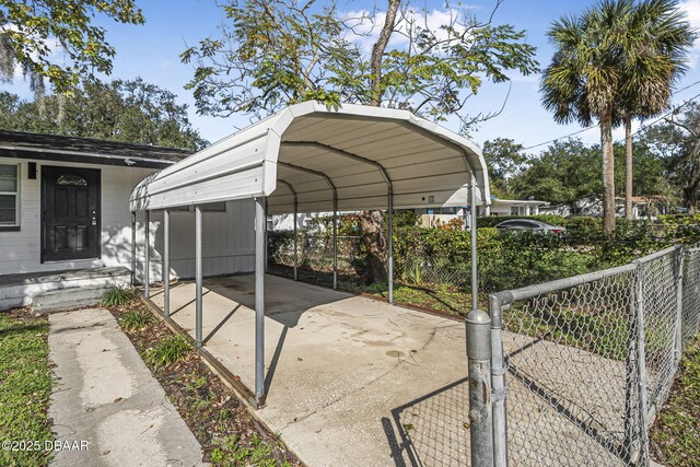 656 Winchester St, Daytona Beach, FL 32114 - view of parking with fence, a detached carport, and driveway