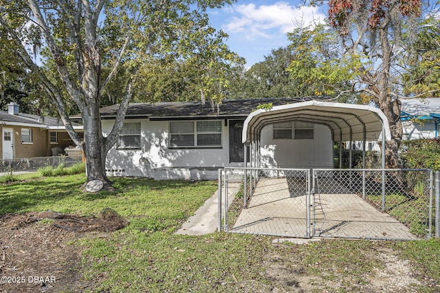 656 Winchester St, Daytona Beach, FL 32114 - view of front of home featuring fence private yard, a gate, a front lawn, and a detached carport
