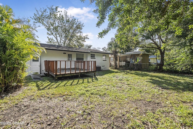 656 Winchester St, Daytona Beach, FL 32114 - rear view of house with a lawn, fence, a wooden deck, and cooling unit