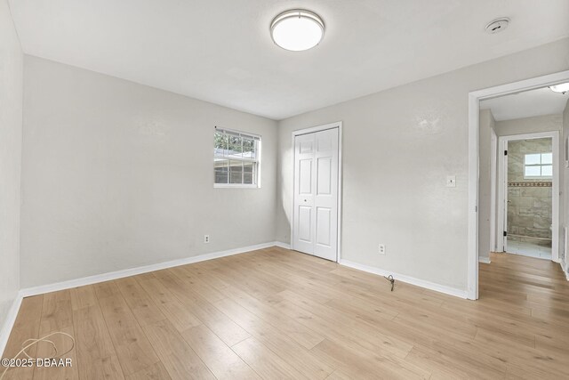 656 Winchester St, Daytona Beach, FL 32114 - unfurnished bedroom featuring baseboards, a closet, and light wood-style flooring