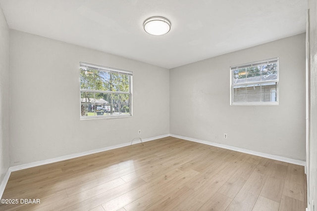 656 Winchester St, Daytona Beach, FL 32114 - empty room featuring baseboards, plenty of natural light, and light wood finished floors