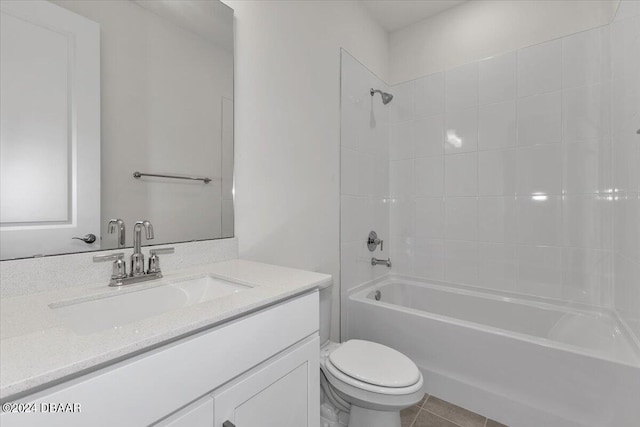 full bathroom featuring tile patterned floors, vanity, toilet, and tiled shower / bath combo