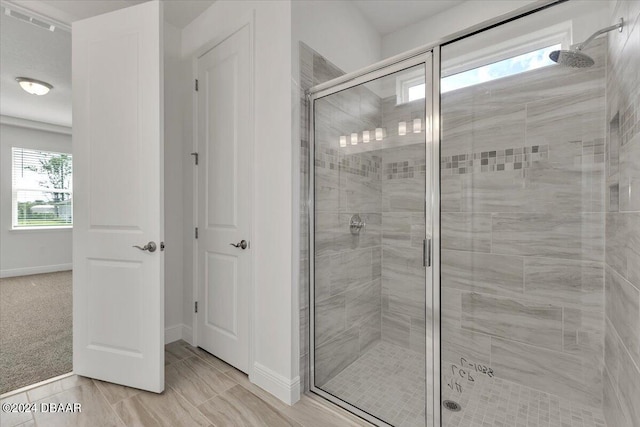 bathroom featuring a healthy amount of sunlight and an enclosed shower