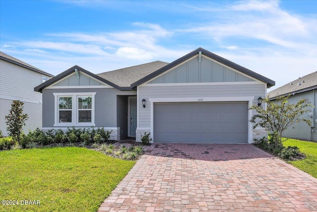 view of front of home with a garage and a front yard