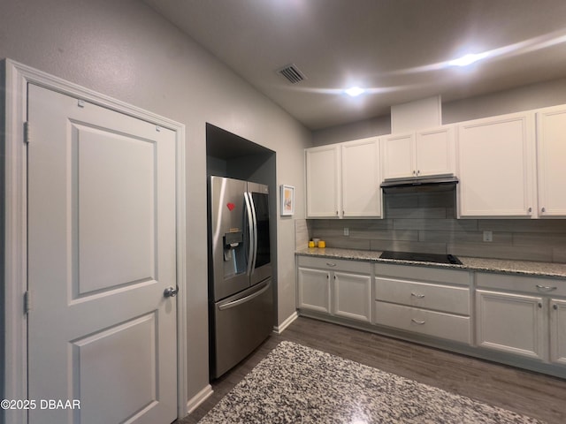 453 Tuscany Chase Dr, Daytona Beach, FL 32117 - kitchen with backsplash, visible vents, white cabinets, black electric stovetop, and stainless steel fridge
