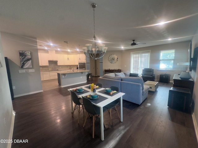 453 Tuscany Chase Dr, Daytona Beach, FL 32117 - dining area with dark wood-style flooring, baseboards, and ceiling fan with notable chandelier