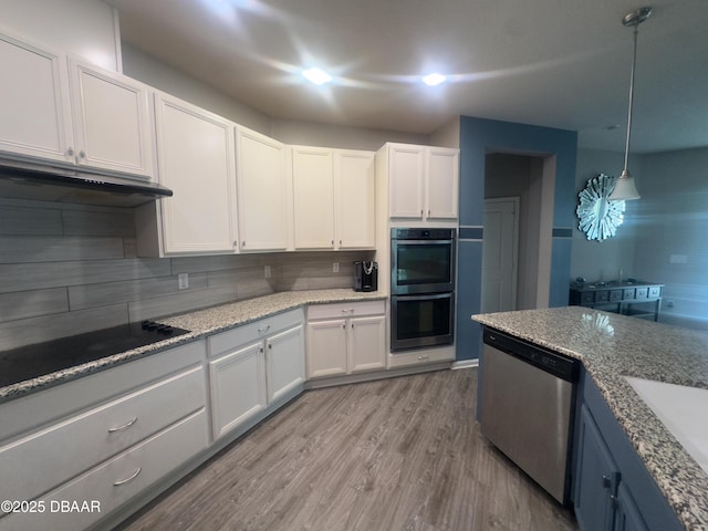 453 Tuscany Chase Dr, Daytona Beach, FL 32117 - kitchen with dishwasher, double oven, black electric stovetop, white cabinetry, and backsplash
