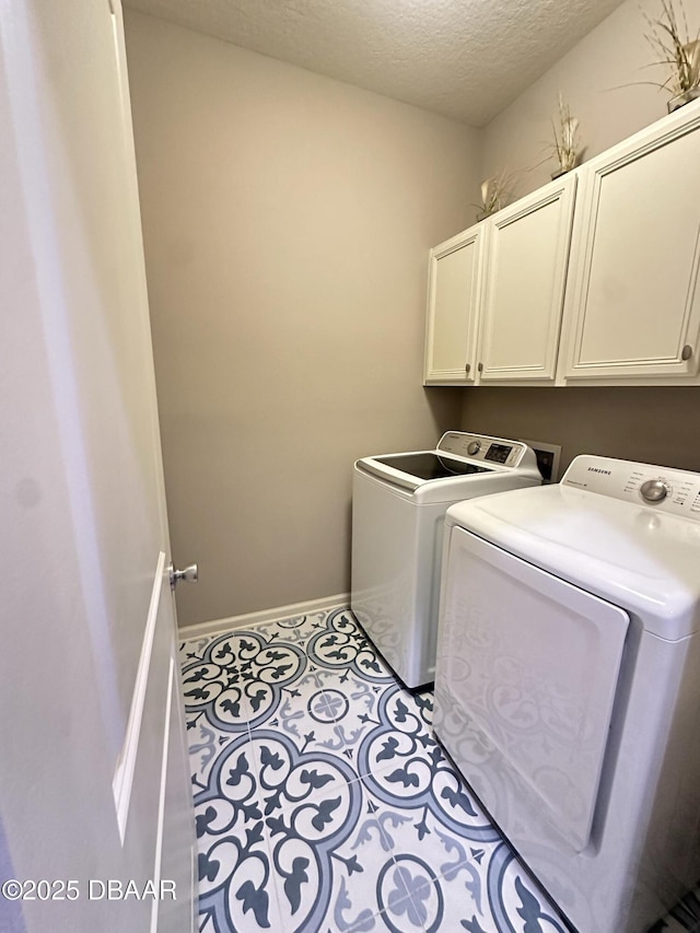 453 Tuscany Chase Dr, Daytona Beach, FL 32117 - clothes washing area with baseboards, a textured ceiling, cabinet space, and washing machine and dryer