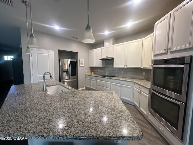 453 Tuscany Chase Dr, Daytona Beach, FL 32117 - kitchen featuring visible vents, decorative backsplash, a sink, dark stone countertops, and stainless steel appliances