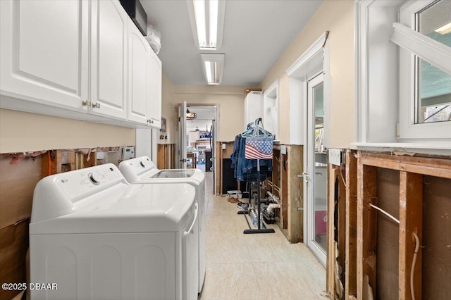 washroom with cabinets and independent washer and dryer