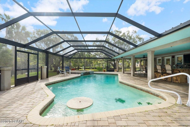 view of swimming pool with a patio area and glass enclosure