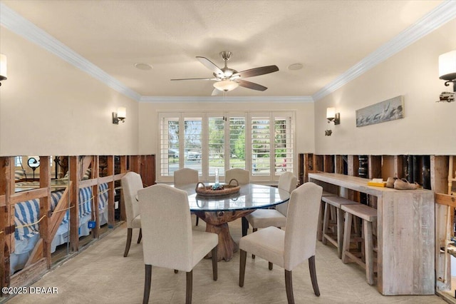 dining room with crown molding and ceiling fan