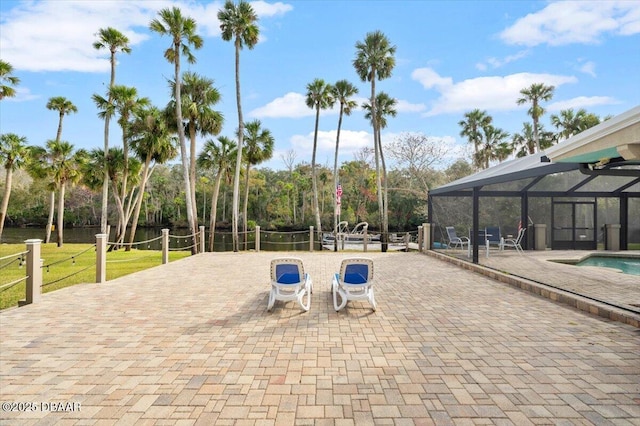 view of patio featuring a lanai