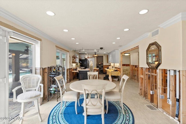 dining room featuring crown molding and a textured ceiling