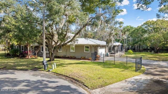 view of front of house featuring a garage and a front lawn