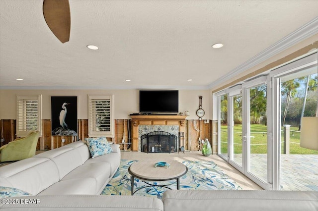 living room featuring crown molding, a high end fireplace, and a textured ceiling