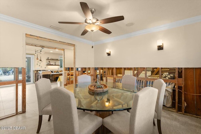 dining space with ceiling fan, ornamental molding, and light tile patterned floors